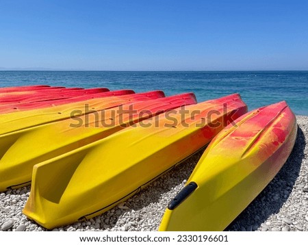 Kayaking on the Beach Concept Photo. Sport Kayak on the Rocky Beach Shore. Close Up Photo. Copy space
