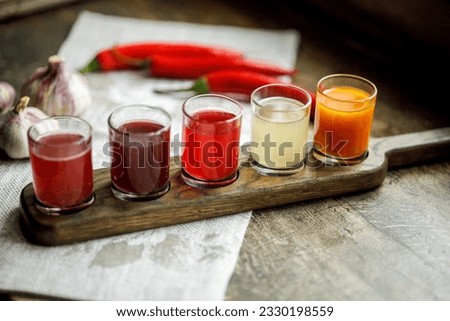 A set of colorful alcoholic tinctures on berries and fruits on a wooden background Royalty-Free Stock Photo #2330198559