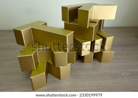 The letters of the outdoor advertising logo in gold color are on the table.Production of advertising for business.Make a street sign.