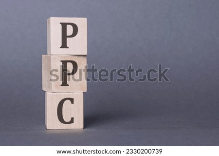PPC or Pay Per Click - letters on wooden cubes. Business as usual concept image. Space for text in right.
