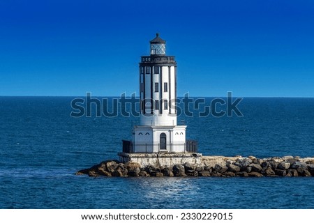 Historic black and white lighthouse a the breakwater at the Port of Los Angeles, California Royalty-Free Stock Photo #2330229015