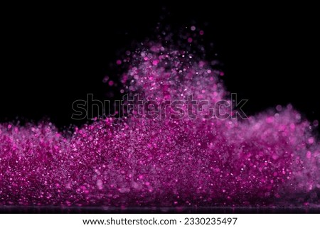 Explosion metallic pink glitter sparkle. Choky Glitter powder spark blink celebrate, blur foil explode in air, fly throw pink glitters particle. Black background isolated, selective focus Blur bokeh