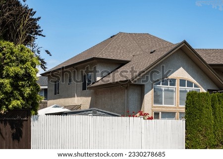 Beautiful exterior house in rural suburban neighborhood. Real Estate Exterior Front House on a sunny day in countryside. Big house with front yard and fence. Beautiful house in A perfect neighborhood