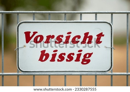  Sign on fence to private property with german inscription vorsicht bissig. Translation: caution biting                              