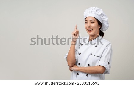Thinking menu Young beautiful asian woman chef in uniform on isolated background. Cooking woman Occupation chef or baker People in kitchen restaurant and hotel.