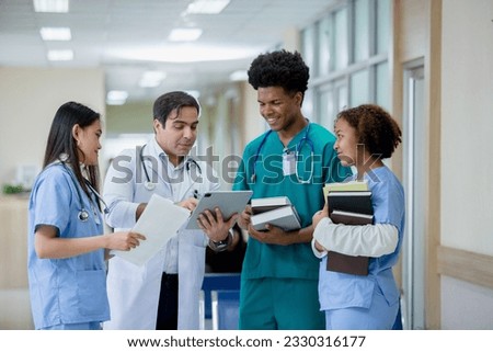 Teacher doctor man and group medical student standing looking work in tablet. education and learning medical concept. nurse students study from professional.