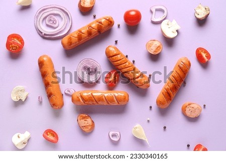 Tasty grilled sausages and vegetables on lilac background Royalty-Free Stock Photo #2330340165