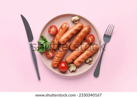 Plate with tasty grilled sausages on pink background Royalty-Free Stock Photo #2330340167