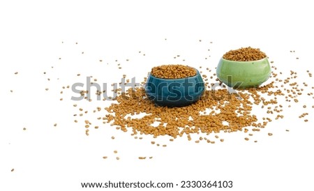 fenugreek seed spice in ceramic bowls, isolated on white background. Fenugreek yellow seeds - Trigonella foenum-graecum.