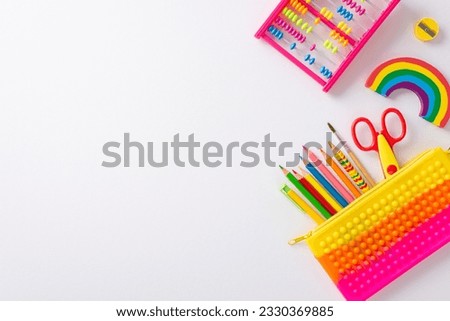 Explore the world of education for small kids through this top view snapshot: abacus, pencil case and vibrant collection stationery on isolated white backdrop, ready for text or advert placement