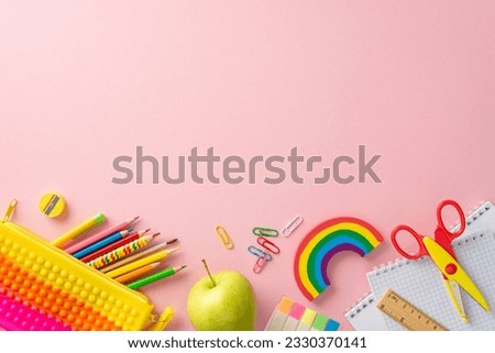 Lower grade necessities. Top view shot showcasing colorful items: notepads, pencil case, drawing pencils, plasticine, sticky memos, clips, scissors, ruler, and apple. Text-friendly pastel background