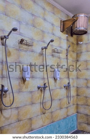 Shower Cabins in Banya Or Bath Interior with Bucket of Cold Water for Dousing.Vertical image Royalty-Free Stock Photo #2330384563