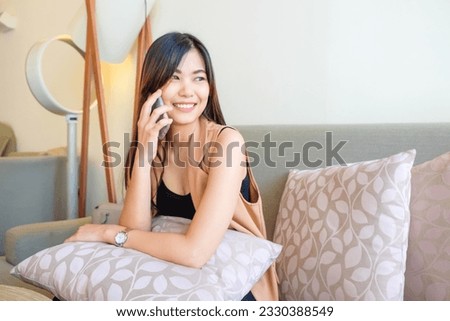 Business woman use smartphone business community sitting on sofa in cozy room