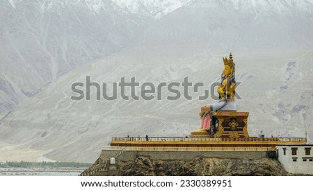 The Maitreya Buddha statue with Himalaya mountains in the background from Diskit Monastery or Diskit Gompa, Nubra valley, Leh Ladakh