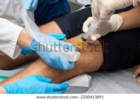 Medical procedure close-up. Doctor makes an injection. Rheumatology Royalty-Free Stock Photo #2330413891