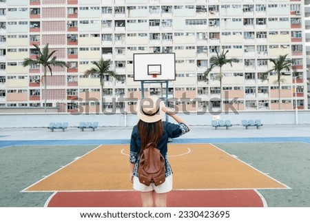 A woman tourist is enjoy traveling at choi hung housing estate famous hipster travel landmark new location in Hong Kong. Royalty-Free Stock Photo #2330423695