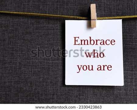 Card with handwritten text EMBRACE WHO YOU ARE - journey of self-discovery and self-acceptance, to accept yourself including your strengths, weaknesses, and imperfections Royalty-Free Stock Photo #2330423863