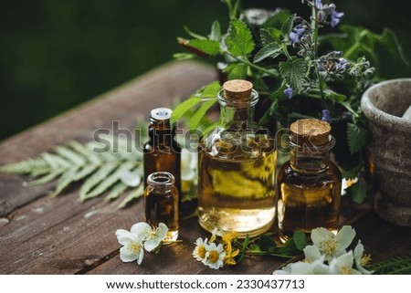 Assortment of organic essential oils, herbal extracts and medical flowers herbs In glass bottles. Alternative therapy, aromatherapy. Natural ingredients in cosmetic and medicine Royalty-Free Stock Photo #2330437713
