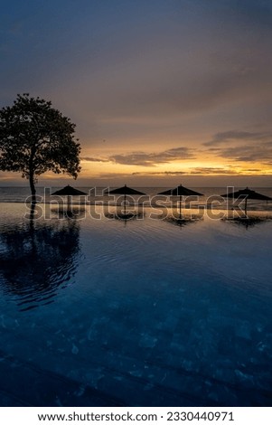 Endless beach pool, sunset sky horizon and colorful clouds. Luxury vacation and holiday concept. Sunset sunrise landscape, outdoor scenic
