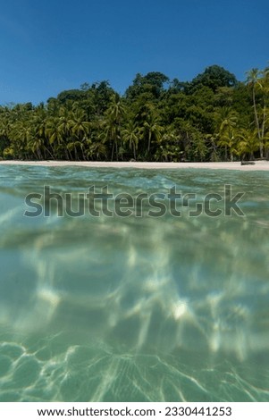 Tropical island beach beyond ocean surface, Coiba island, Pacific Ocean, panama - stock photo