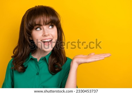 Photo of dreamy pretty lady wear green shirt holding arm looking empty space isolated yellow color background