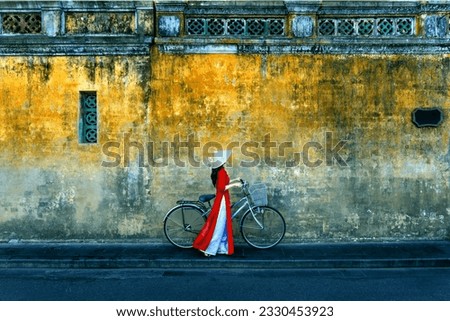 Asian woman wearing vietnam culture traditional at Hoi an, Vietnam. Royalty-Free Stock Photo #2330453923