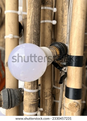 close up light bulb on wooden poles
