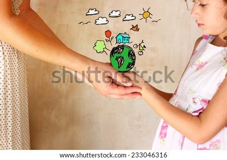 photo of mother and child holding hands and showing a better world concept with set infographics . protection and education concept Royalty-Free Stock Photo #233046316