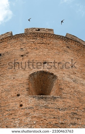 Fragments of the old fortress. From red brick. Fortress loopholes. Royalty-Free Stock Photo #2330463763