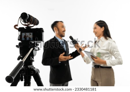 one set of standing camera recording a beautiful journalist in white blouse interviewing an adult men in black suit