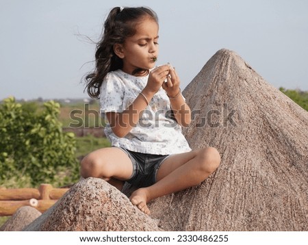Wonderful portrait photo with smiling little brown haired girl. Concept happy and beauty kid with good healthy with blur background. Six year child wearing white and black in garden.
