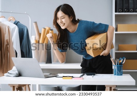 Happy young Asian woman entrepreneur, Smile for sales success after checking order from online shopping store in a laptop at home, Concept of merchant business online and eCommerce.