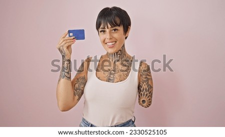 Hispanic woman with amputee arm smiling confident holding credit card over isolated pink background