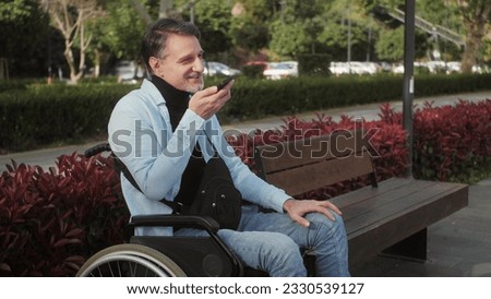Positive disabled man Middle eastern man dictation voice message and sending using mobile phone. Disability and lifestyle concept. Royalty-Free Stock Photo #2330539127