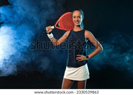 Junior padel tennis player with racket. Open day. Girl athlete with paddle racket on court. Sport concept. Download a high quality photo for the design of a sports app or social media publication.