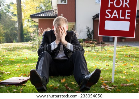 Resigned real estate broker sitting on the grass