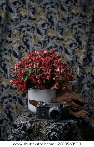 a vintage film camera with rose bouquet 