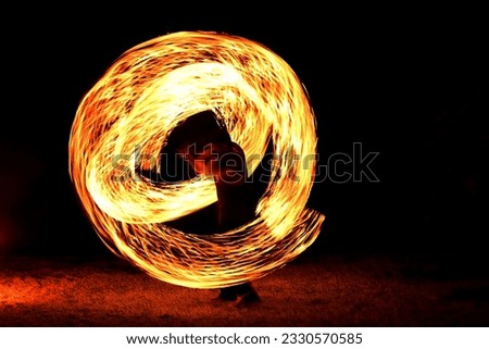 Fire moving in circle by slow speed shutter at dark background