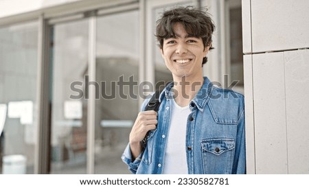 Young hispanic man student smiling confident standing at university