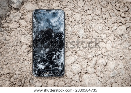 Black broken touch screen phone with cracked screen