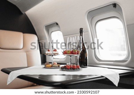 Business jet plane interior with leather comfortable seats. Private airplane transfer  Royalty-Free Stock Photo #2330592107