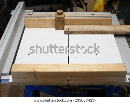 DIY cross cut sled on a table saw. A piece of wood will be cut.  Royalty-Free Stock Photo #2330594239