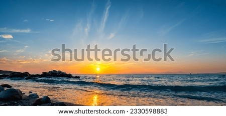 Paradize beach with blue tirkiz water, sand and rocks on morning with rising sun and on sunset. High resolution.