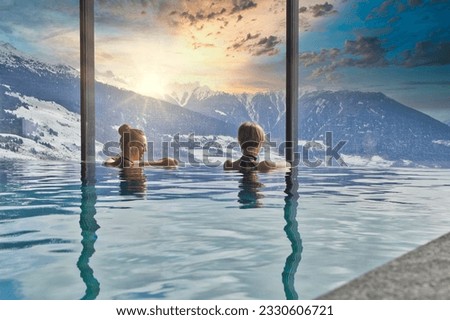Women enjoying the panoramic view from the pool in the alps Royalty-Free Stock Photo #2330606721