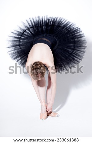 young beautiful dancer posing on a studio background