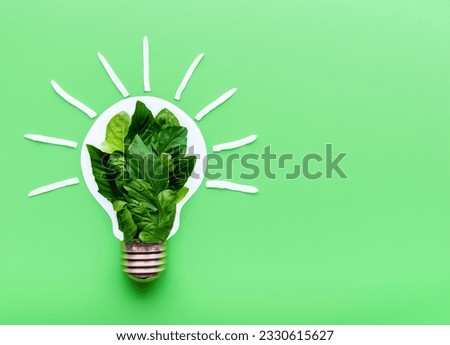 Green Eco-Friendly Lightbulb from Fresh Leaves - Sustainable Concept for Nature, Environment, and Renewable Energy.