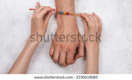 Happy Raksha Bandhan Holiday Background. Indian sister is wearing rakhi bracelet on his indian brother