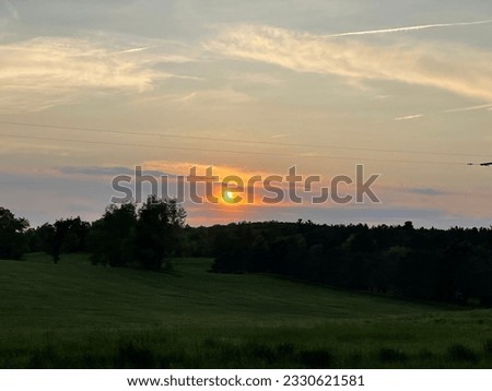 Sunset over green field summer 