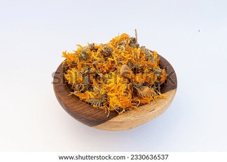 Calendula Flower on a wooden plate isolated on a white background