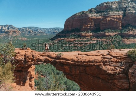 Travel in Devil's Bridge Trail, scenic view panoramic landscape in Sedona, Arizona, USA. Happy Couple on the famous trail in Sedona. High quality photo Royalty-Free Stock Photo #2330643951